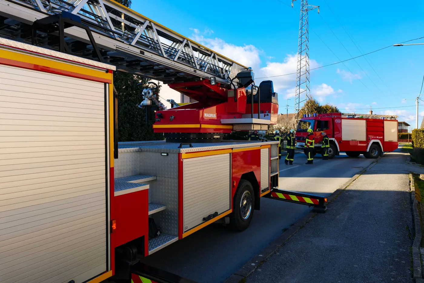 Firefighters and fire trucks working on a city street