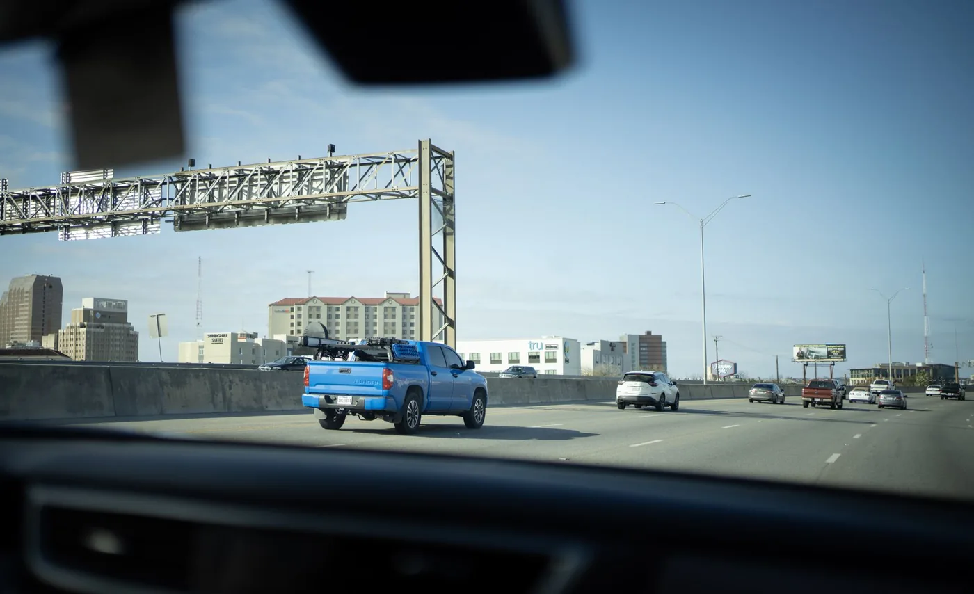 Shot of vehicles on a bustling city highway, capturing urban commute dynamics.