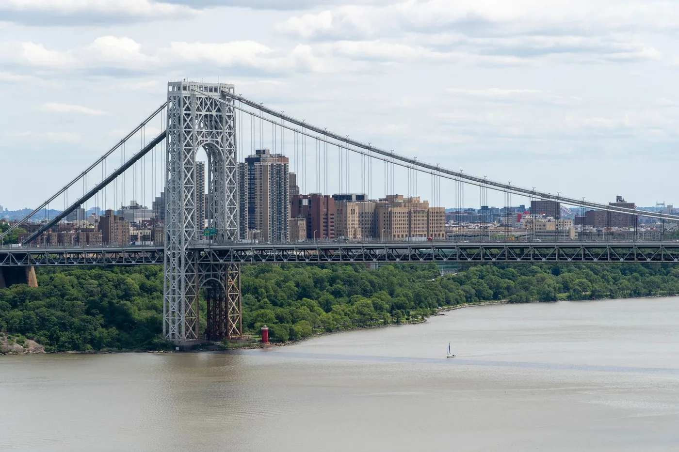 Stunning view of George Washington Bridge spanning the Hudson River with Manhattan cityscape backdrop.