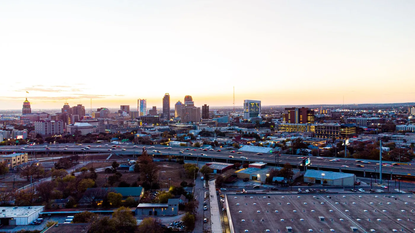 A breathtaking aerial view of San Antonio's skyline during sunset, showcasing its urban charm and high-rise buildings.