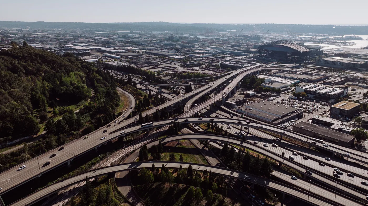 Highway interchange in Seattle with cityscape background, captured during the day.