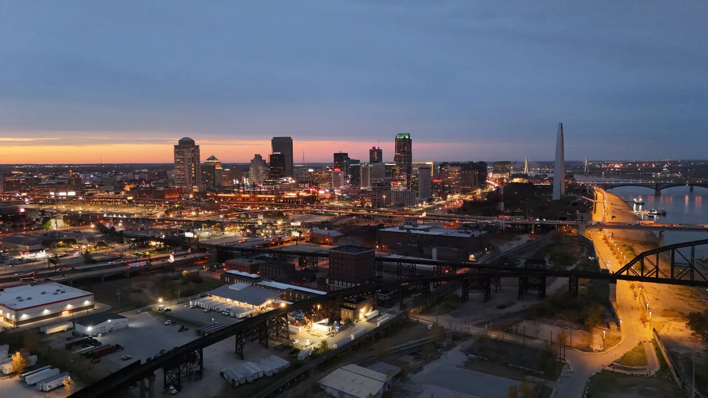 Aerial view of St. Louis skyline at night featuring the iconic Gateway Arch.
