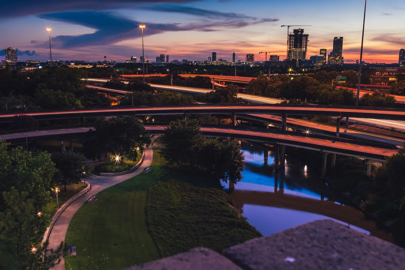 Vibrant Houston skyline at night with illuminated freeways and cityscape.