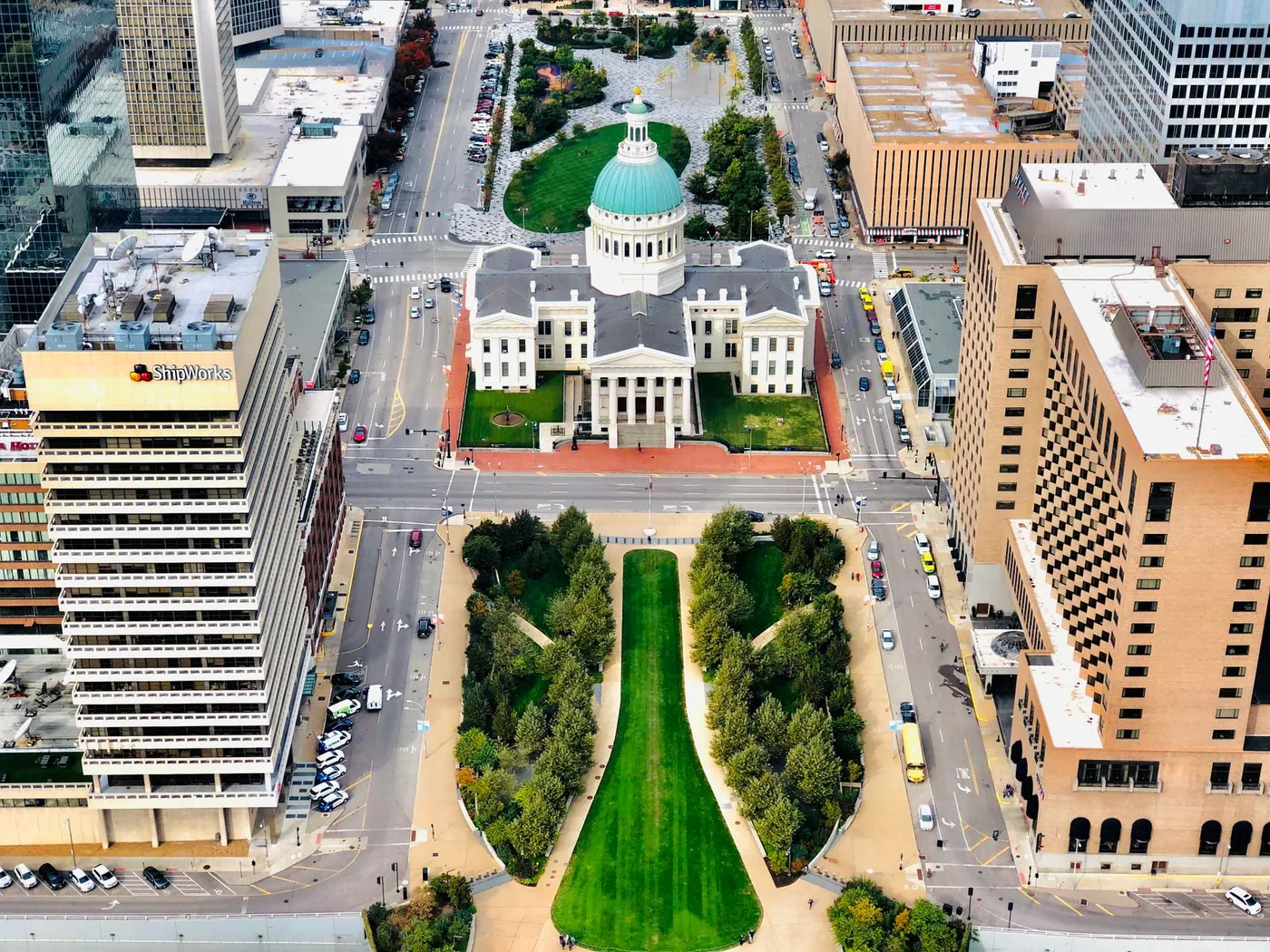 A stunning aerial view of the historic Old Courthouse in downtown St. Louis surrounded by city buildings.