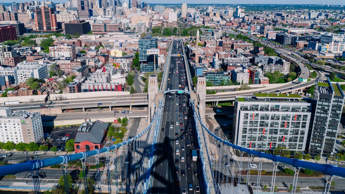 A stunning aerial view of the Benjamin Franklin Bridge and Philadelphia skyline on a clear day.