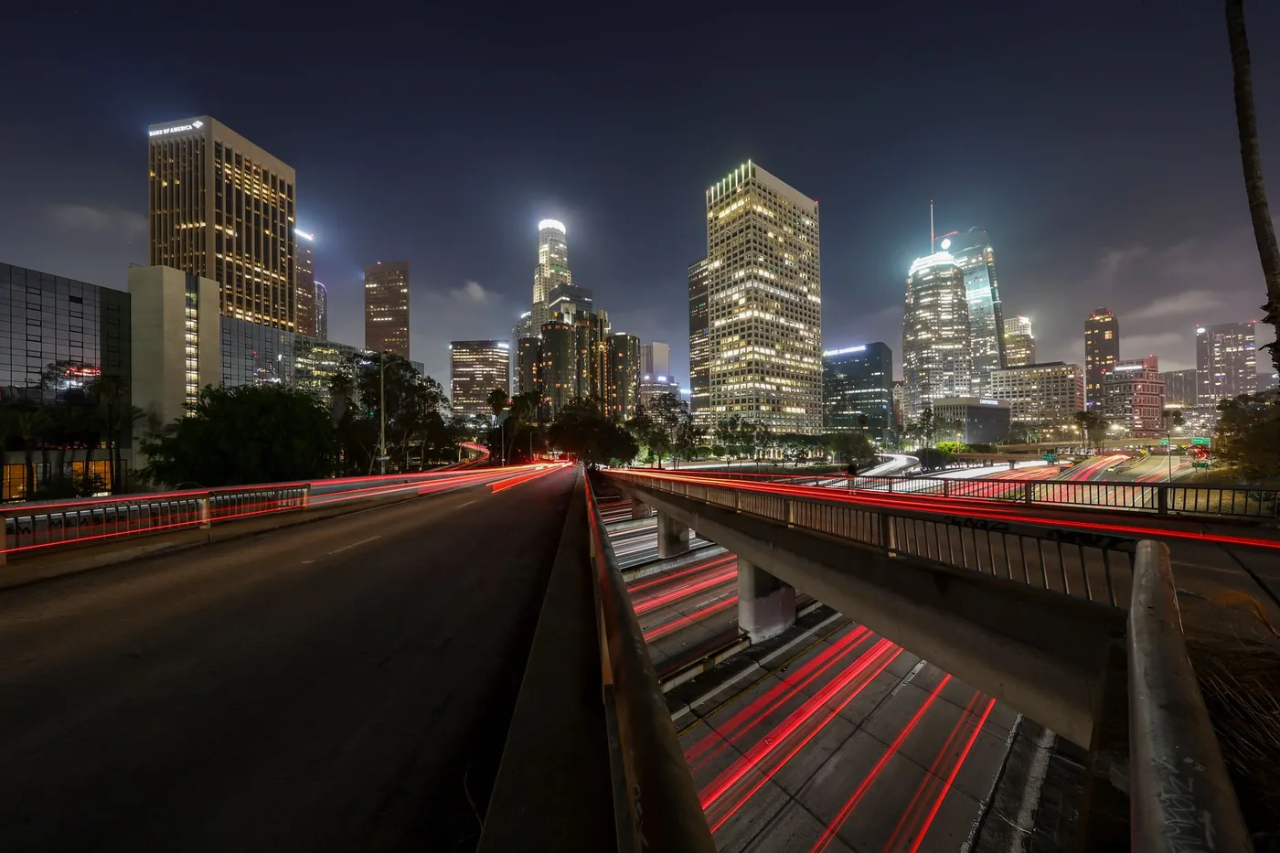 Stunning long exposure of Los Angeles downtown skyline at night with light trails.