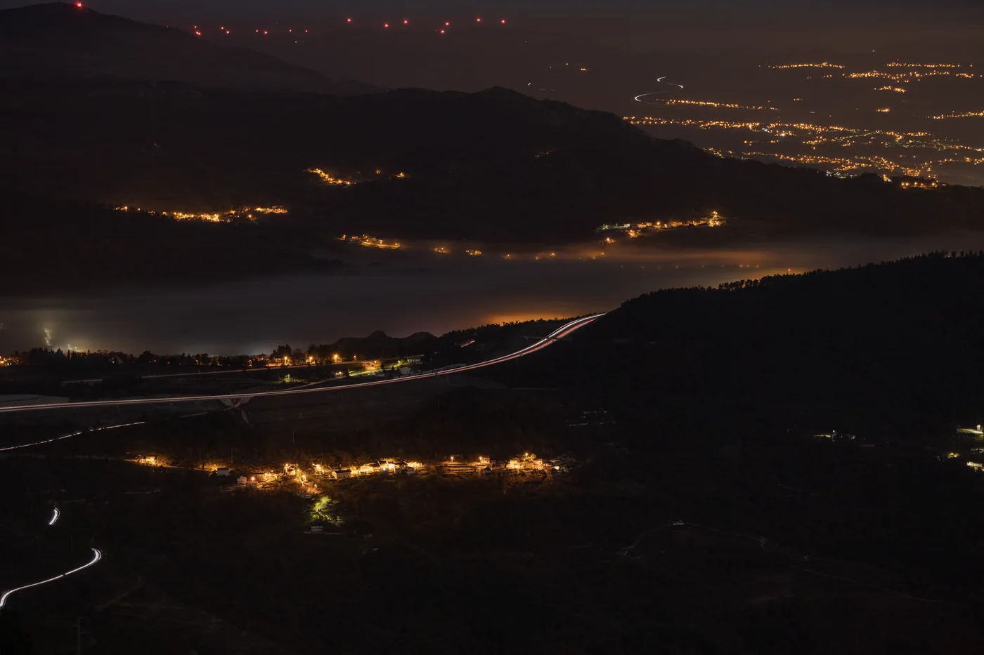 Dramatic aerial nighttime landscape with lights and hills in Vila Real District, Portugal.