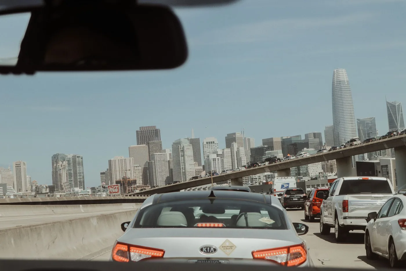 View from a car in traffic with San Francisco skyline on a clear day.