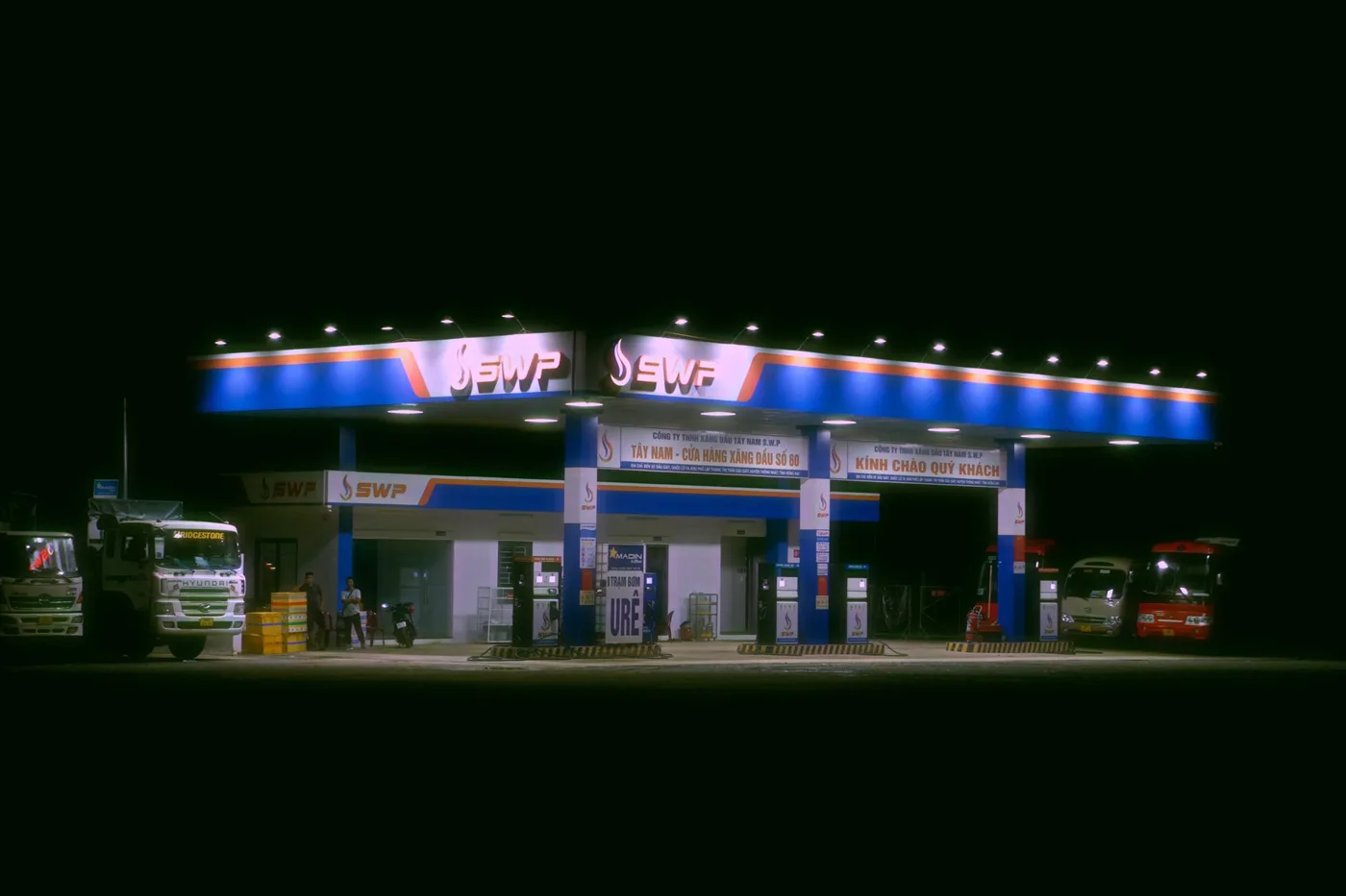 A travel plaza truck stop along an interstate at dusk