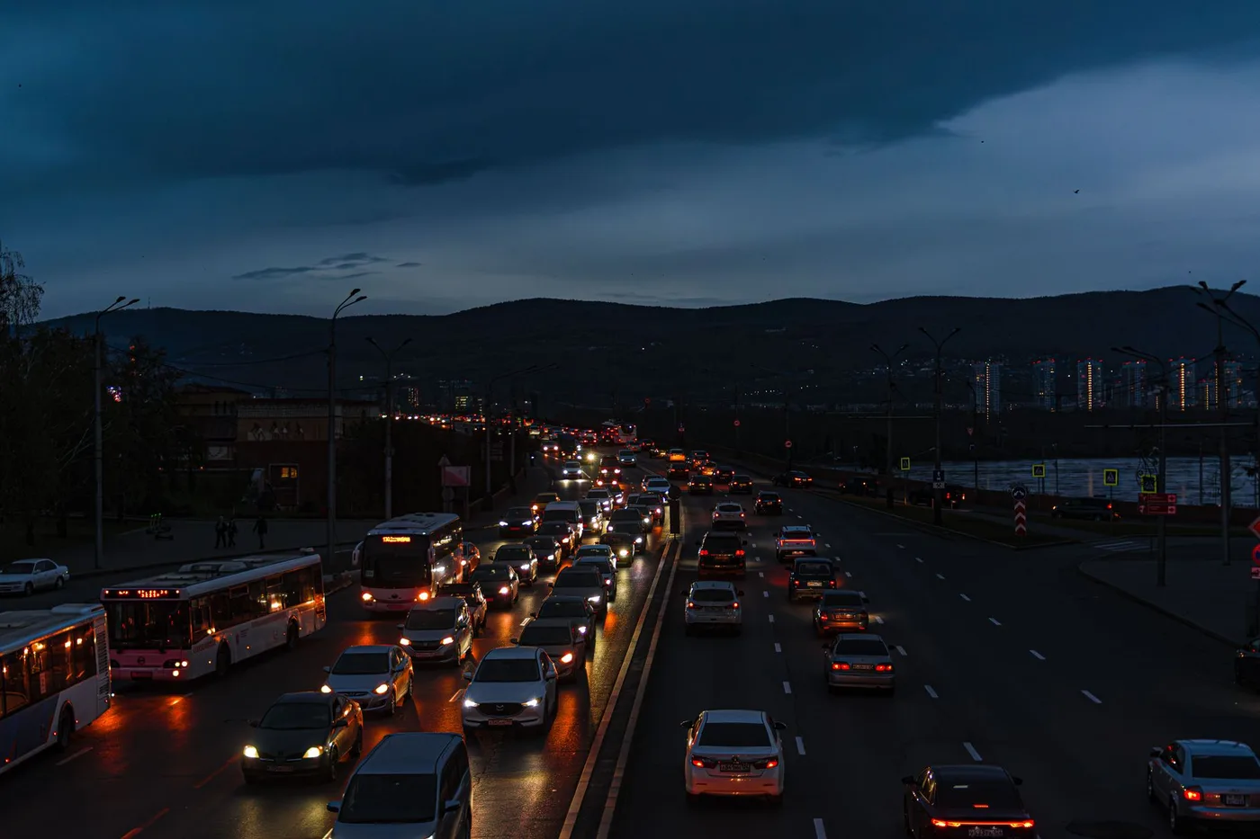 A vibrant scene of night traffic on a city highway, showcasing bustling urban life.