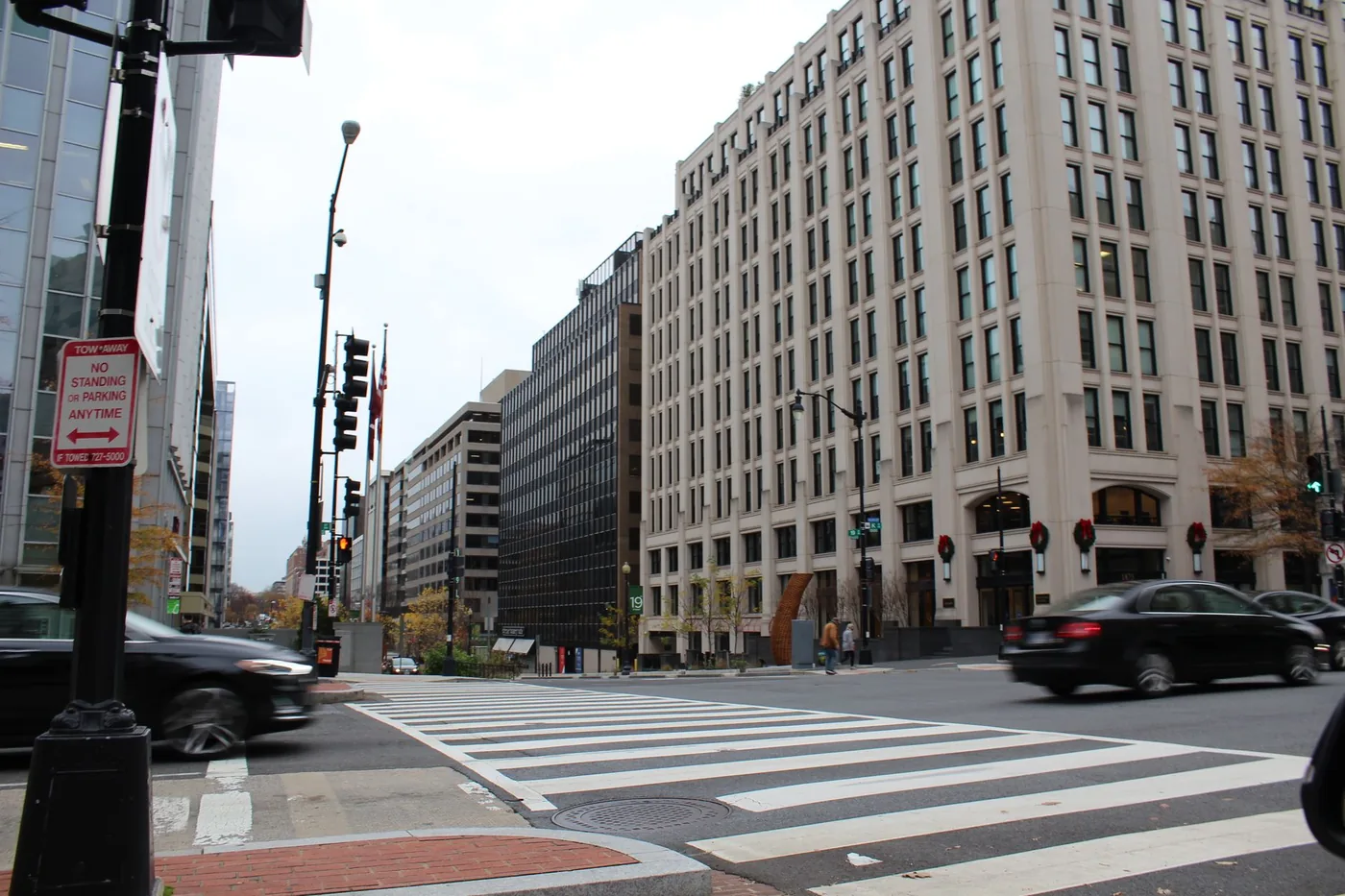Dynamic city street scene in Washington, DC showcasing modern architecture and bustling traffic.