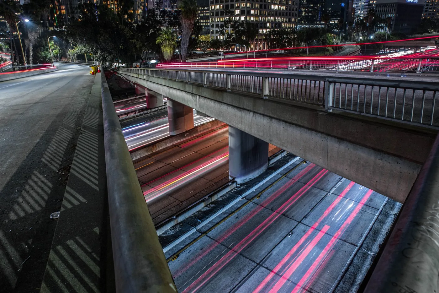 Captivating view of light trails on expressways and bridges in Los Angeles at night, showcasing urban life.