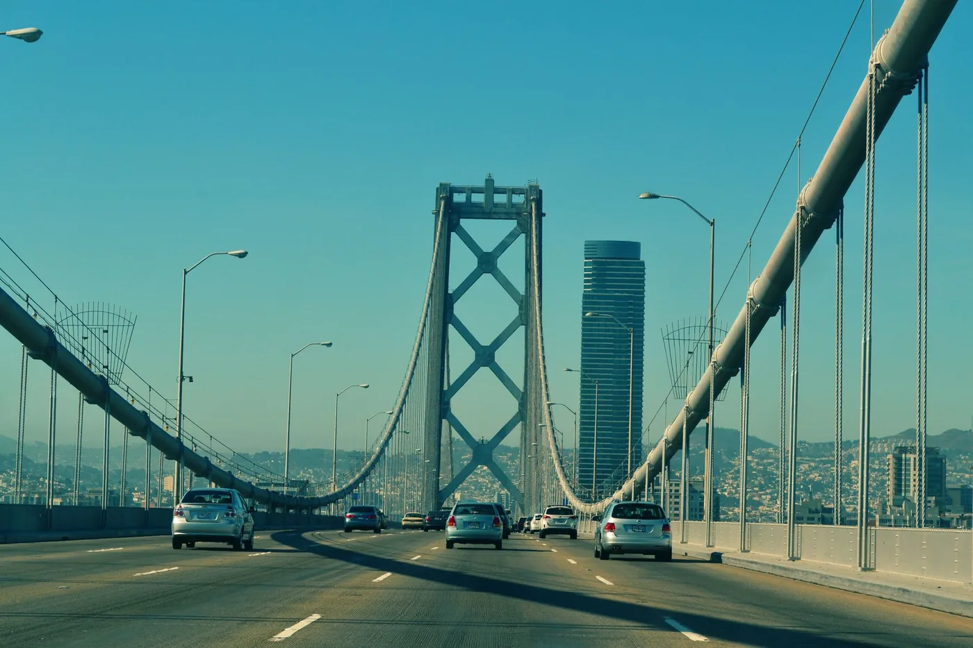 View of vehicles driving across the iconic San Francisco Bay Bridge on a clear day.