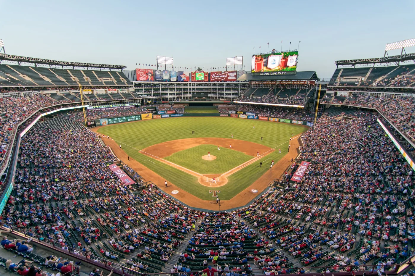 Aerial view of a baseball game at Globe Life Park in Arlington, Texas, beside the I-30 corridor.