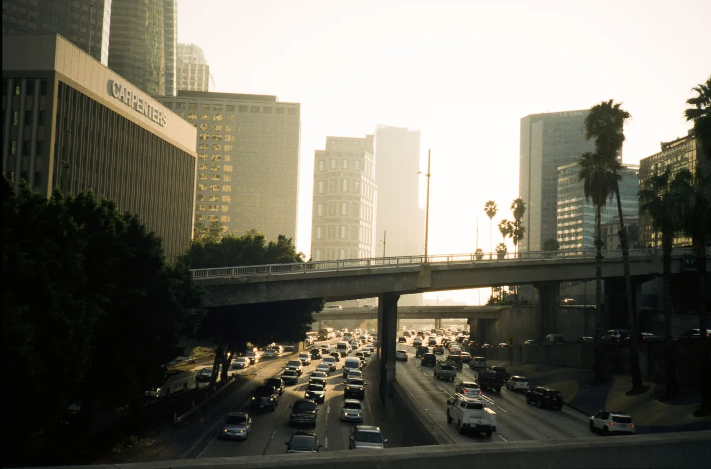 Los Angeles freeway traffic with city skyline during commute hours