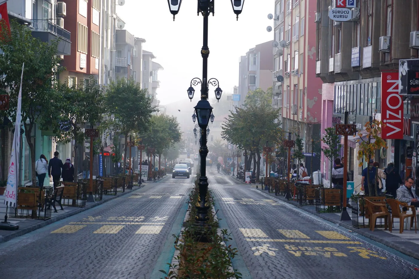 City street with shops along a weekday commute corridor
