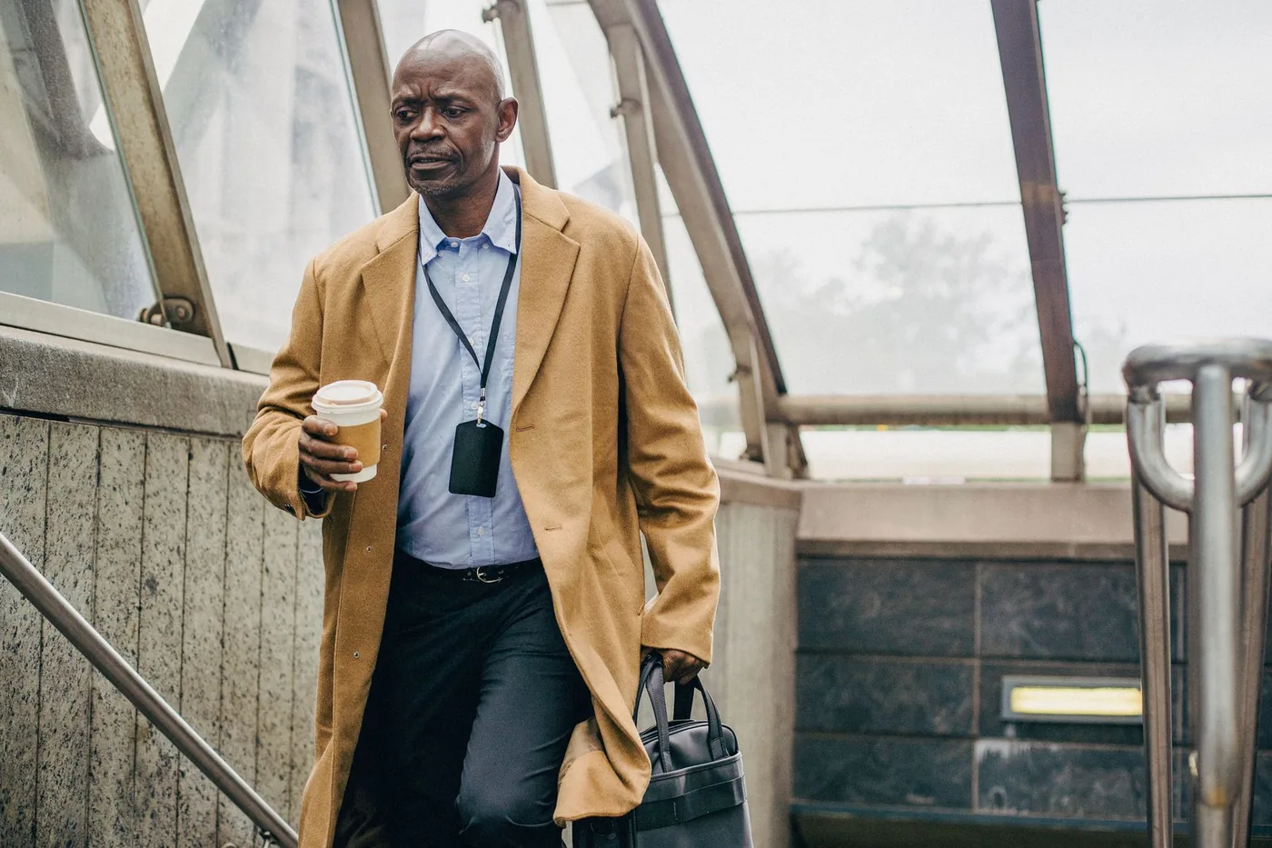 Commuter carrying coffee on a morning walk to work